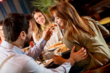 Young people having dinner in the restaurant
