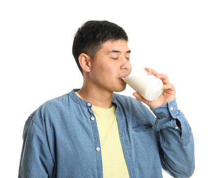 Young Asian Man Drinking Milk On White Background