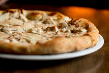 Pizza with cheese and chicken in carbonara sauce