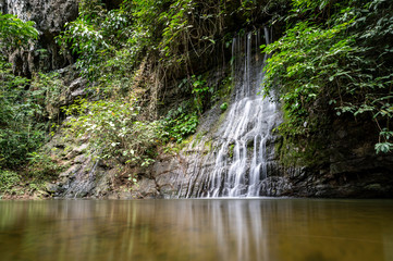 Fototapeta na wymiar Waterfall with a river in the jungle