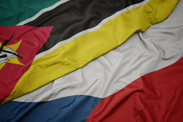 waving colorful flag of czech republic and national flag of mozambique.