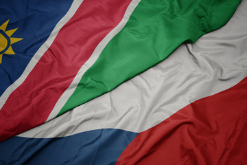waving colorful flag of czech republic and national flag of namibia.