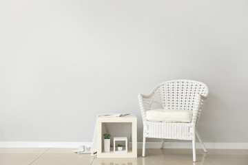 Interior of modern room with comfortable armchair near white wall