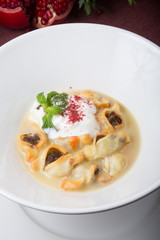 Bowl of fried dumpling served with sour cream