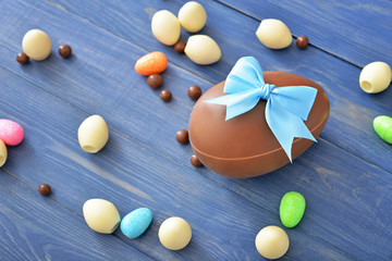 Chocolate eggs and candies on wooden table