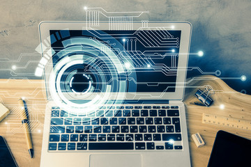 Double exposure of desktop computer and technology theme hologram. Concept of software development.