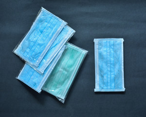 Coronavirus covid-19 prevention travel surgical face masks with black background. 