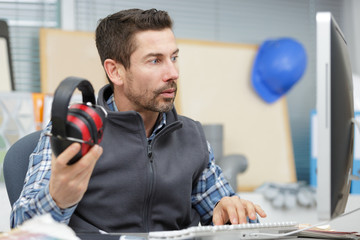 close up of builder with headphones in the office