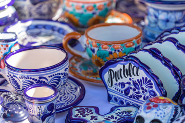 Colorful traditional Mexican pottery. Talavera style. Souvenirs on sale in local market of Cholula, Mexico.