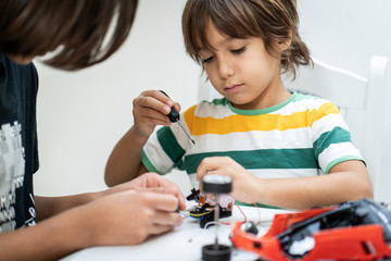 Kids building robot at robotic technology school lesson