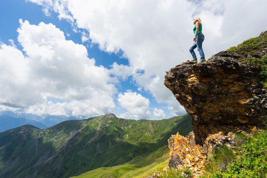 Woman tourist on the top of rock. Svaneti, Georgia. Selective focus.