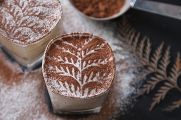 Traditional italian dessert tiramisu on glass on the black background