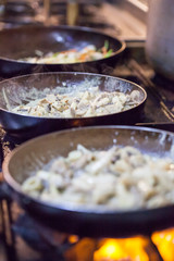 A kitchen of an Italian restaurant, baking Pasta