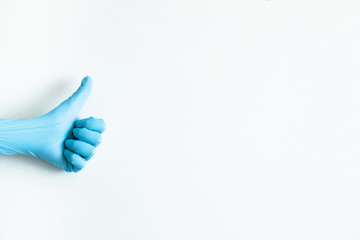 Код стоковой фотографии без лицензионных платежей: 1695500611
Blue medical gloves on the white background. Coronavirus rules .
