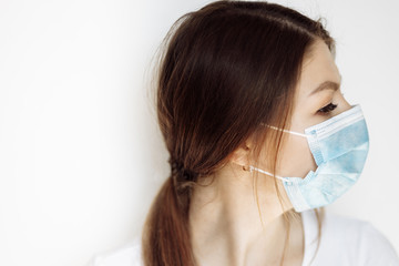 Portrait of young woman wearing medical face mask . Stop coronavirus .  Covid-19 Pandemic of yhe world 