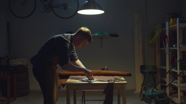 Shoemaker makes a leather pattern at home