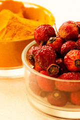 Spices close - up-turmeric powder and rosehip berries.