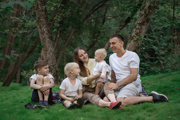Naklejka na ściany i meble Family enjoying picnic in the summer. Big happy family resting together.