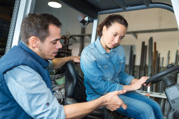 female fork lift truck driver in factory