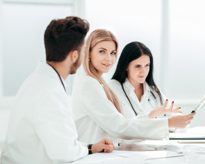 radiologist doctor showing an x-ray to her colleagues.