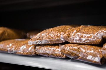 Pockets with buckwheat on the shelf in supermarket