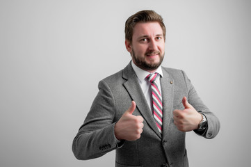 Portrait of business man wearing business clothes showing double obscene gesture