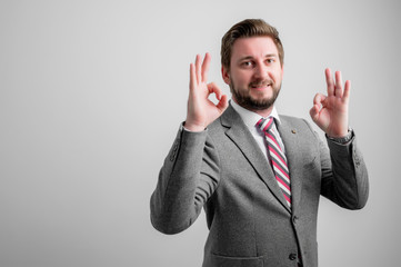 Portrait of business man wearing business clothes showing double ok gesture
