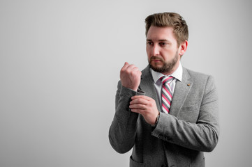 Portrait of business man arranging his business jacket