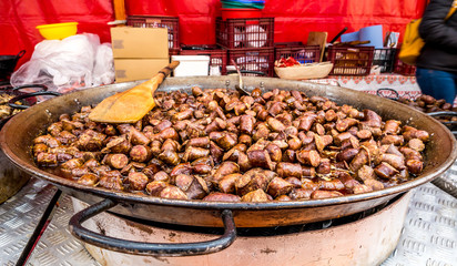 Huge tray with fried pieces of sausage at a food fair in Romania. Traditional romanian pork sausages.