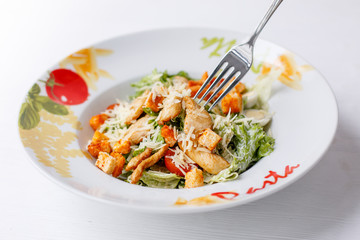 Caesar salad with chicken salad leaves on a light background, menu