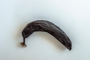 dried banana spoiled brown fruit on a white background close-up