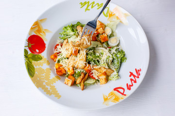 Caesar salad with chicken salad leaves on a light background, menu