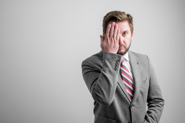 Portrait of business man wearing business clothes covering one eye