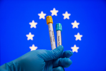 Corona virus or Covid-19 in European union, sample blood tube in hand with European union flag on background