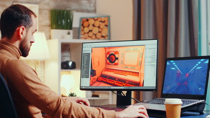 Young game developer using modern software