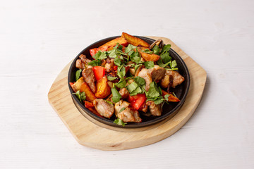 fried potatoes with meat served in a frying pan