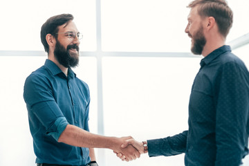 meeting and shaking hands with business people in a bright office