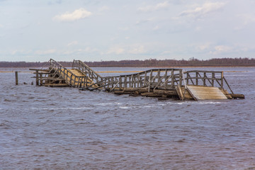 Flooded dilapidated wooden bridge