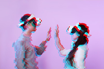 Couple in love communicate using a virtual reality headset. Image with glitch effect.