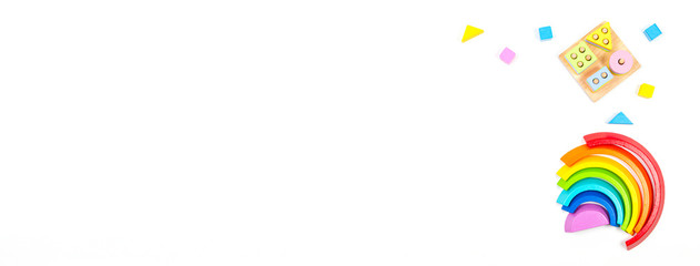 Toys banner background. Wooden educational toys for baby kids on white background. Top view