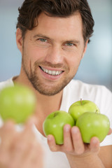 man holding a green apples