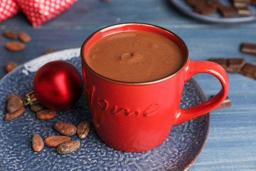 Cup of hot chocolate and Christmas decor on table