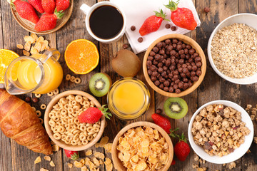 breakfast cereals assortment with orange juice, croissant and strawberry