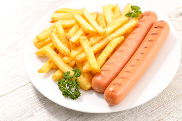 french fries and sausage in plate