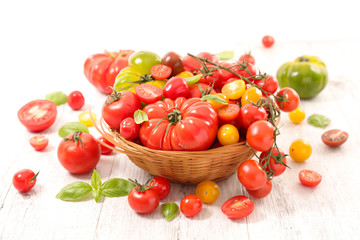 wicker basket with various colorful tomato and basil