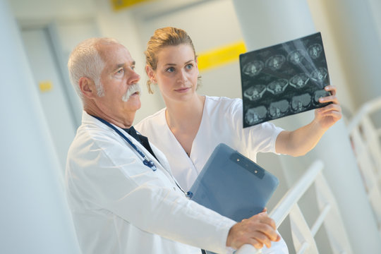 medic and assistant looking at x-ray
