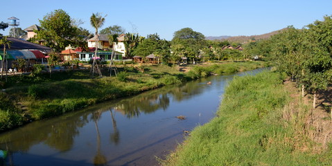 Fototapeta na wymiar Bungalows next to Pai river at Pai Thailand