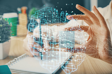 Multi exposure of writing hand on background with brain hologram. Concept of learning.