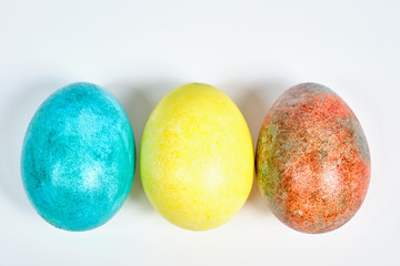 Multicolored, painted Easter eggs on a white background. space for text