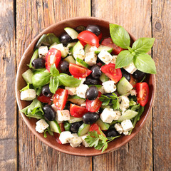 mixed vegetable salad with tomato, olive, red onion, feta cheese and basil